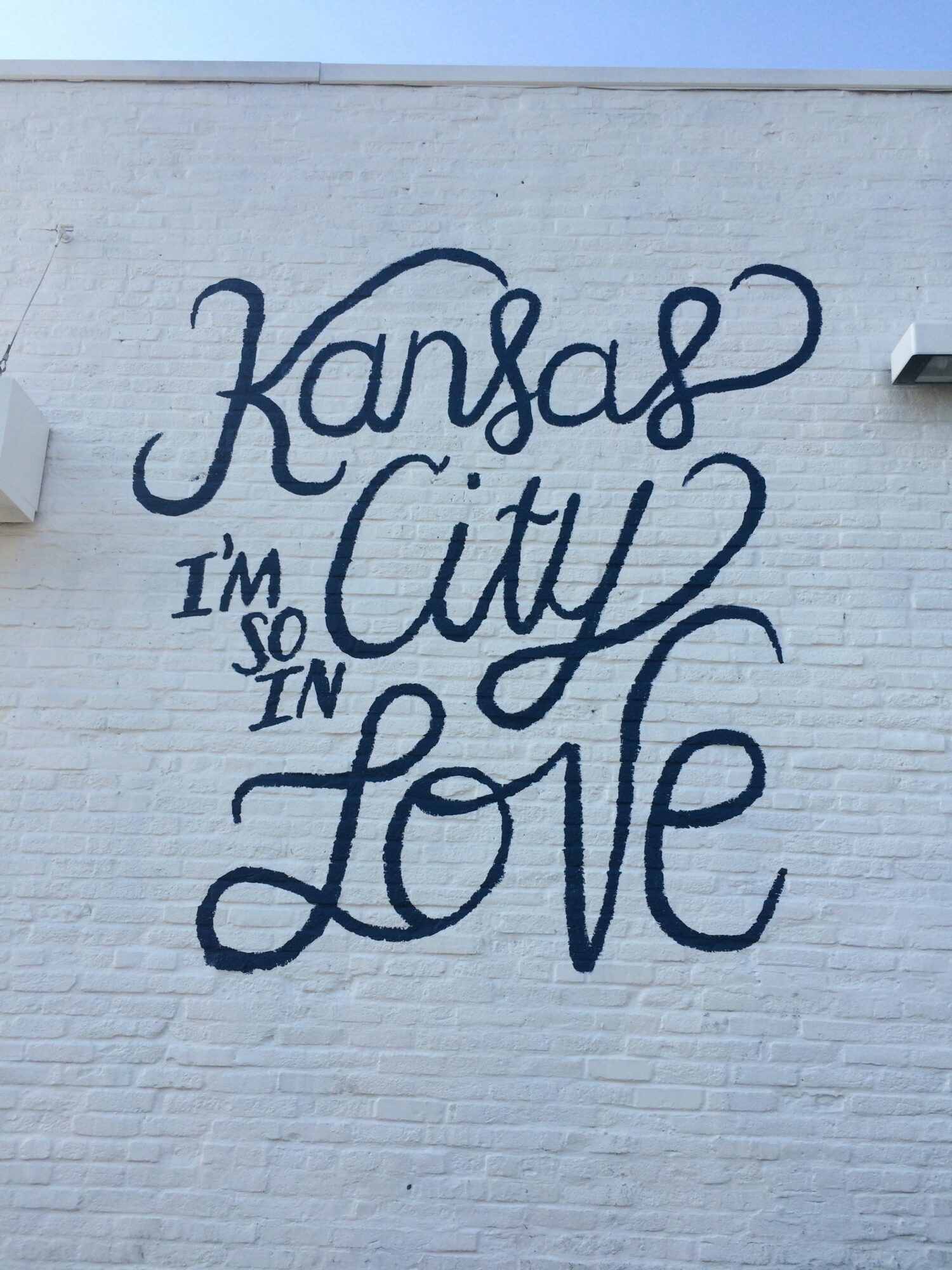 Wall mural with handwritten text: Kansas City Love, and smaller text: I'm so in.
