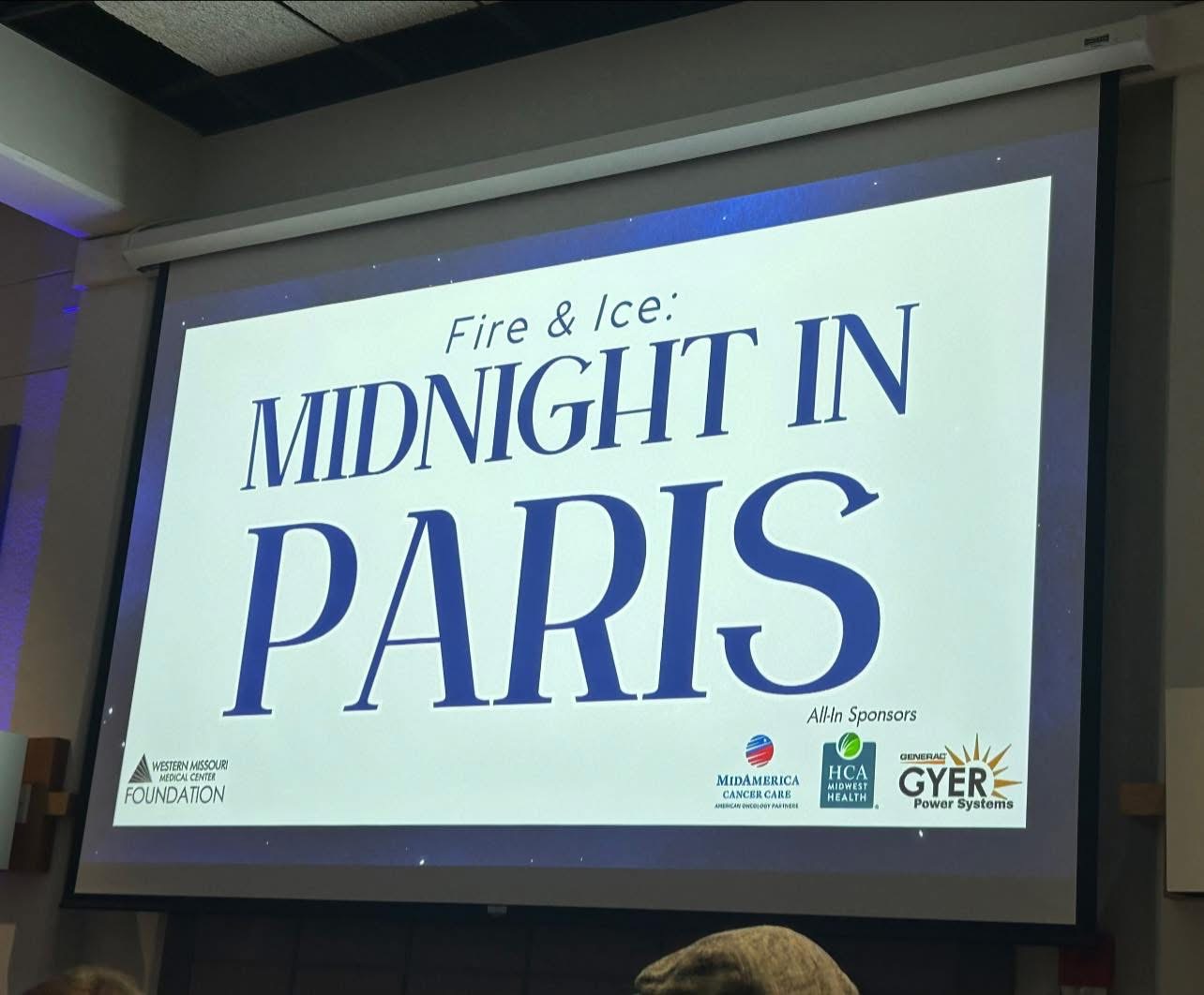 Projection screen displays event title 'Midnight in Paris' with sponsor logos at bottom right.