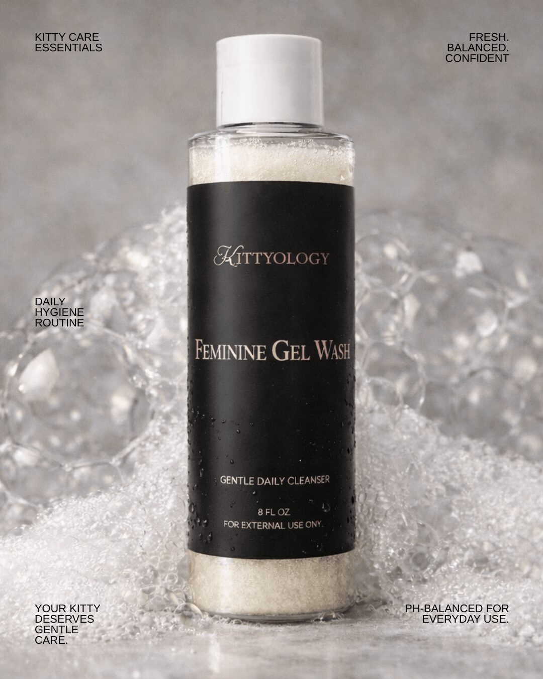 Bottle of Kittyology Feminine Gel Wash on ice with water splashes, black label, white cap, and text around it.