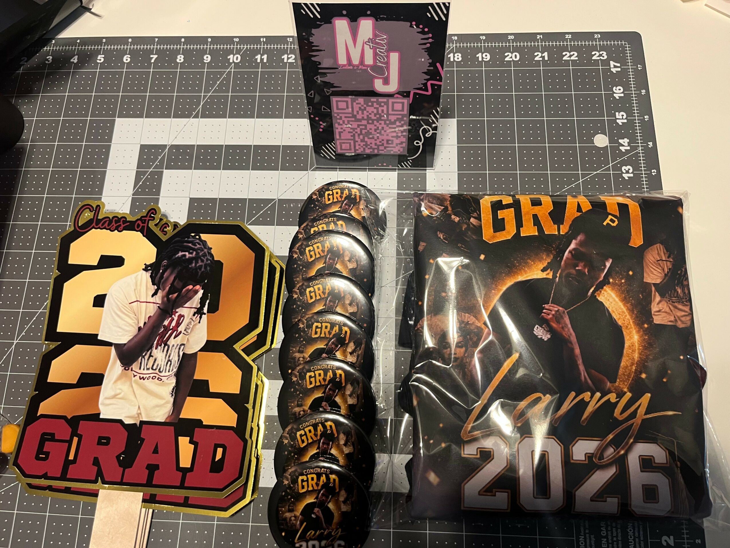 Collection of graduation-themed items including a decorated card, a box of medals, and a booklet with a person on the cover.