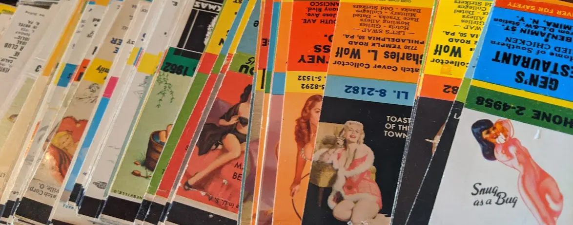 Stack of colorful magazines or brochures with various images and text, fanned out on a surface.