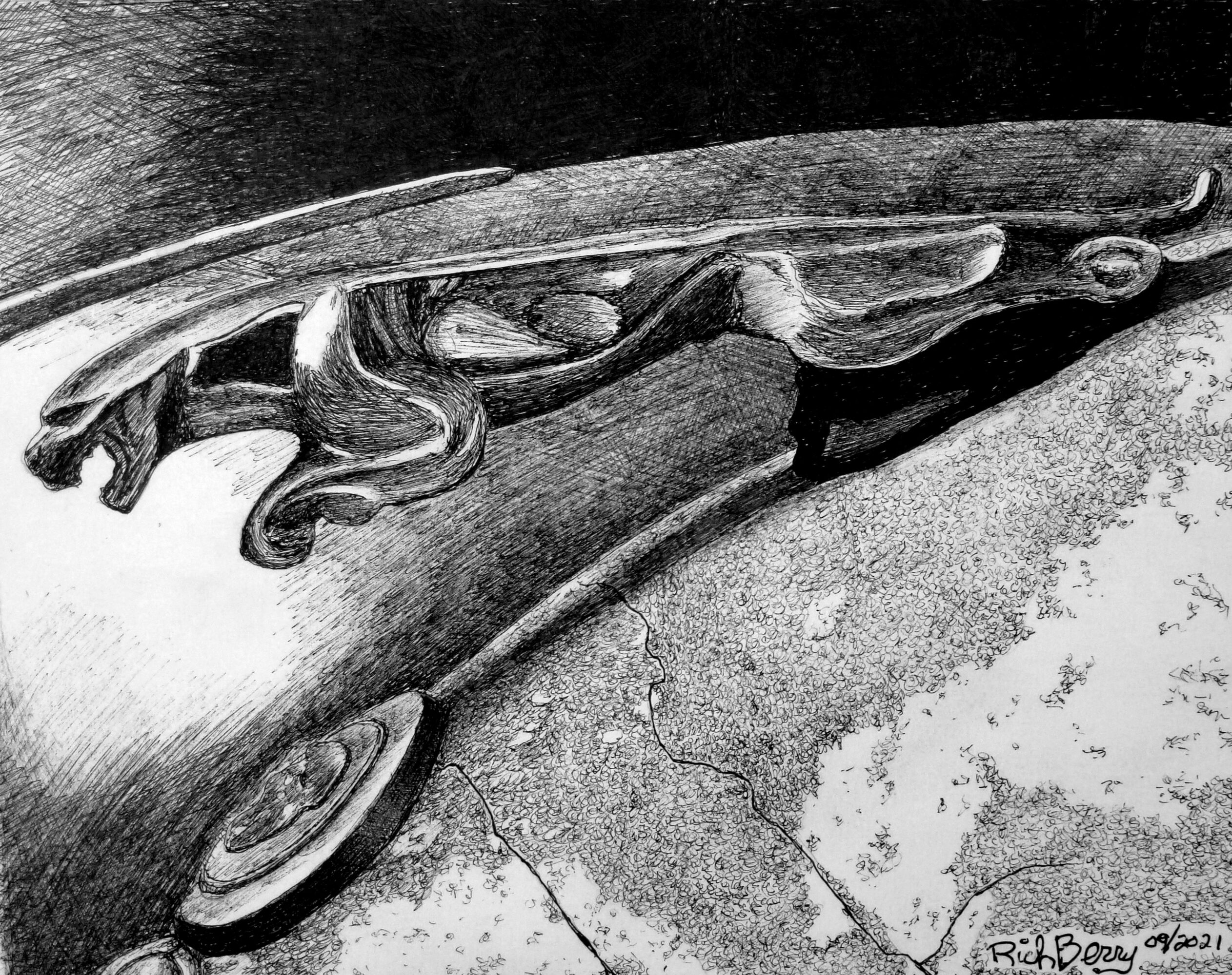 Close-up of a decorative metal handle on a surface, with intricate design and a curved shape.