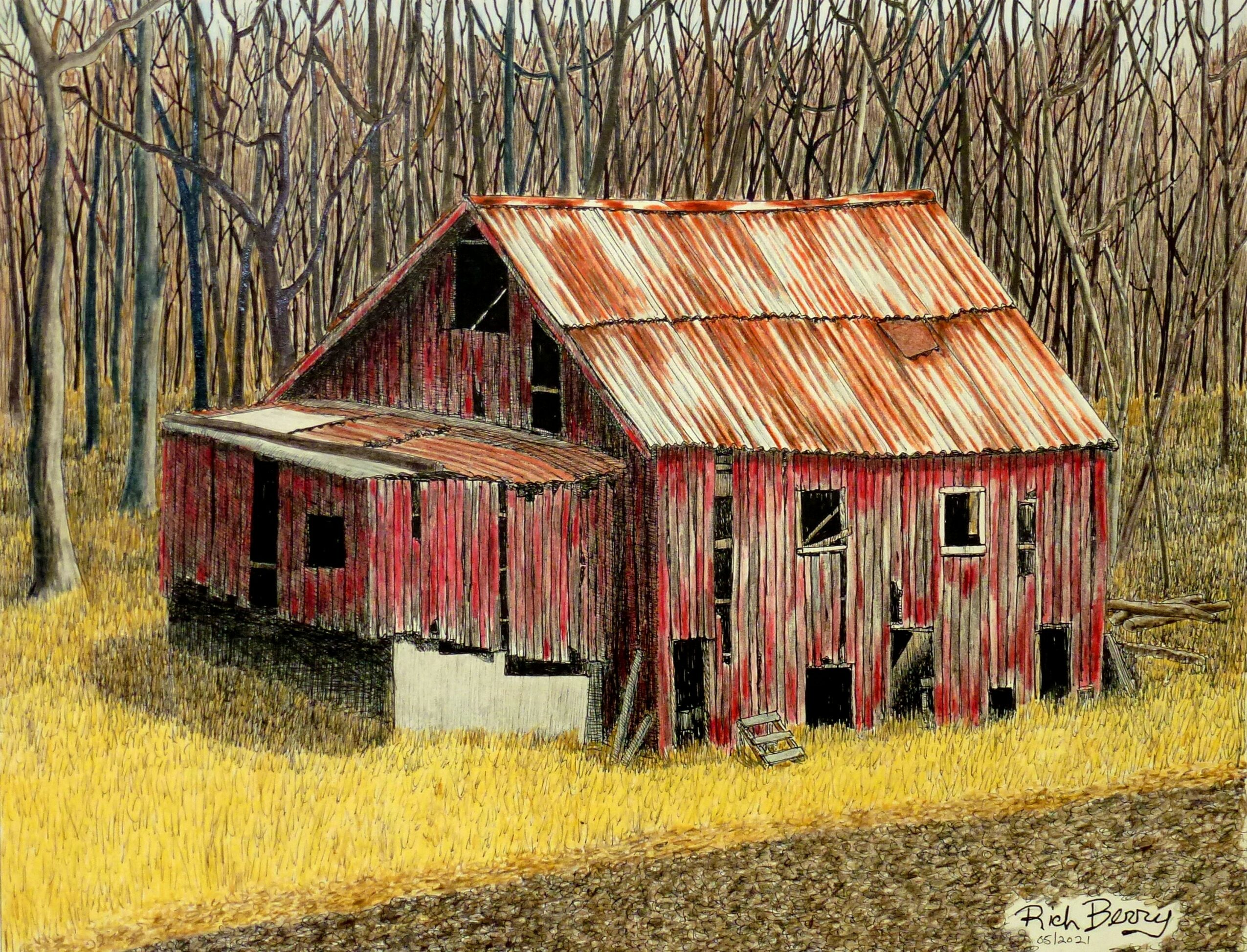 Old red barn with rusted metal roof in a wooded area, surrounded by grass and trees.