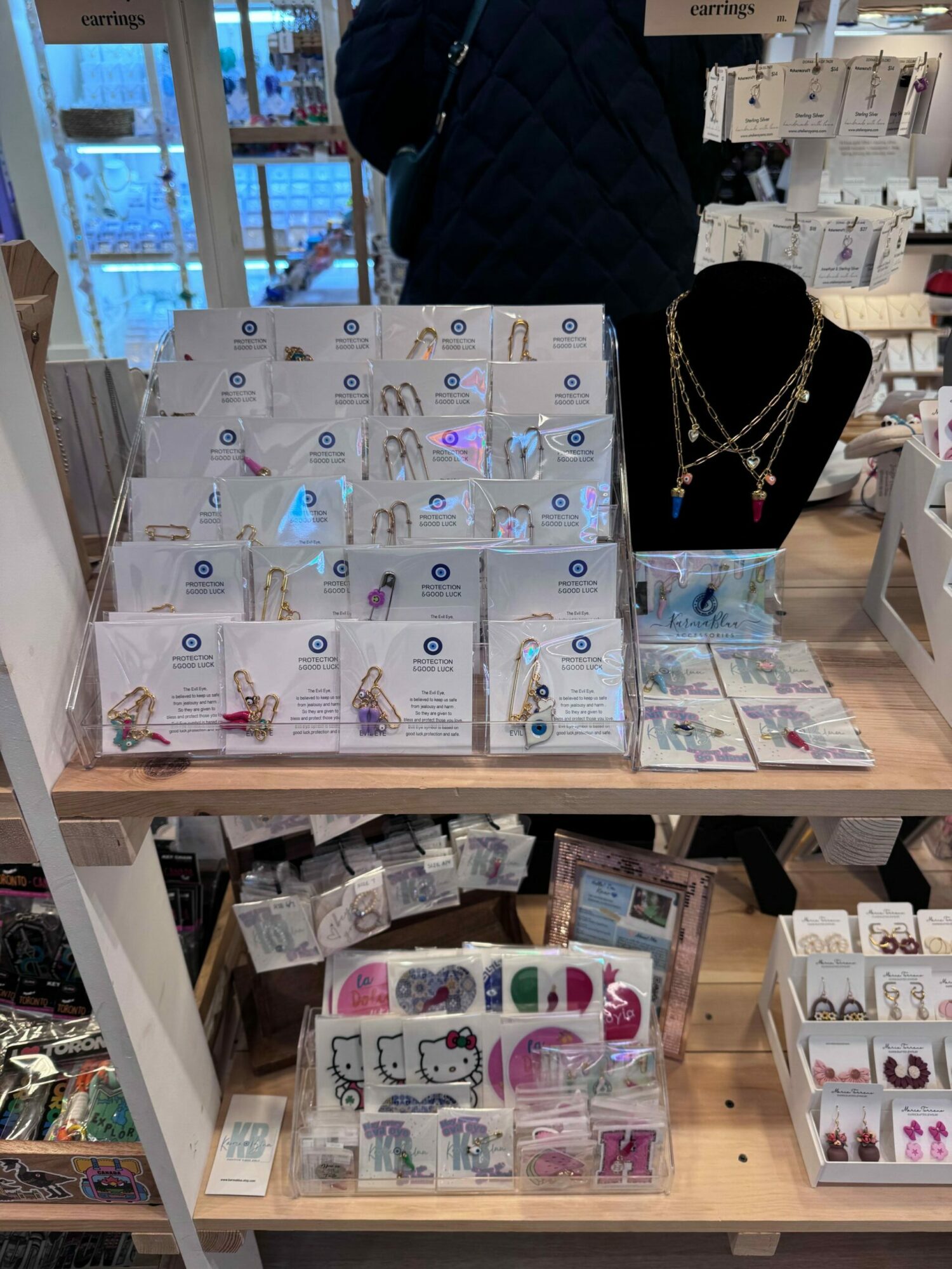 Display of jewelry and accessories on a store counter with various items and packaging visible.