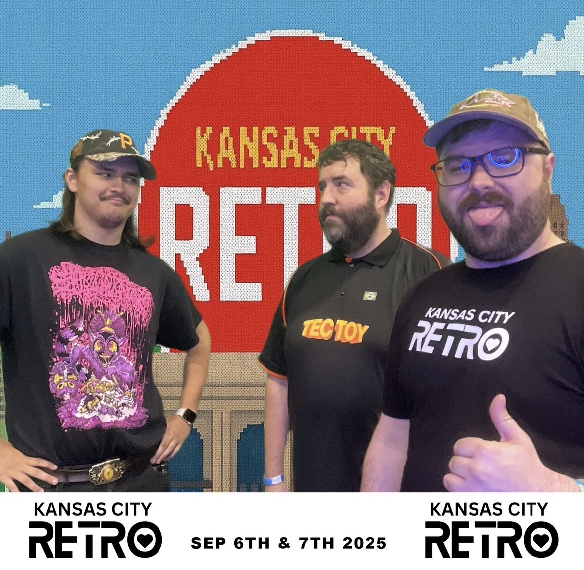 Three people standing in front of a Kansas City Retro sign, smiling and posing for the photo.