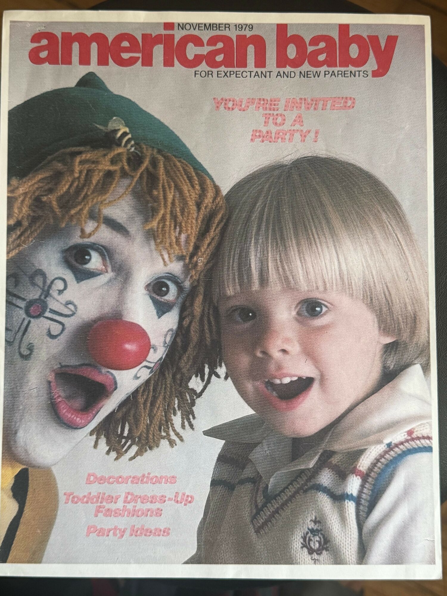 Cover of American Baby magazine featuring a child and a clown with face paint and a red nose.
