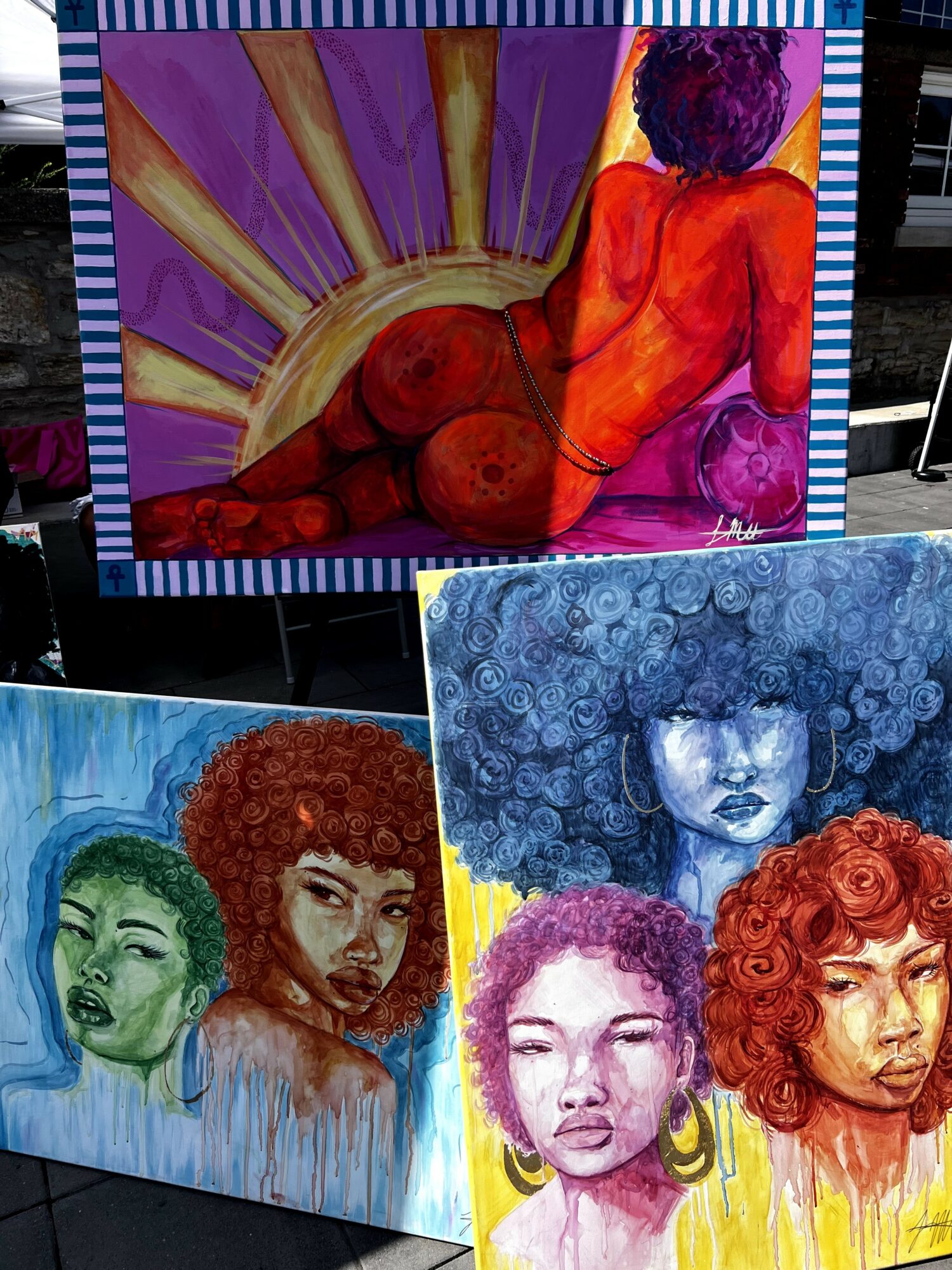 Three colorful paintings featuring abstract and portrait styles, with vibrant colors and expressive faces.