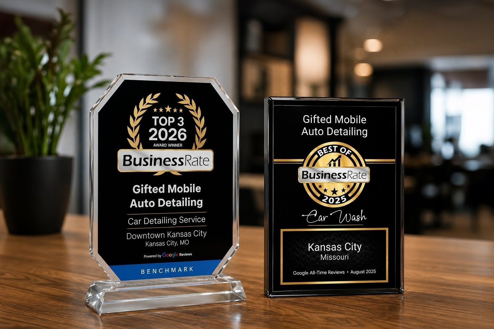 Award plaque and framed certificate for mobile auto detailing business on a wooden table, with a blurred indoor background.