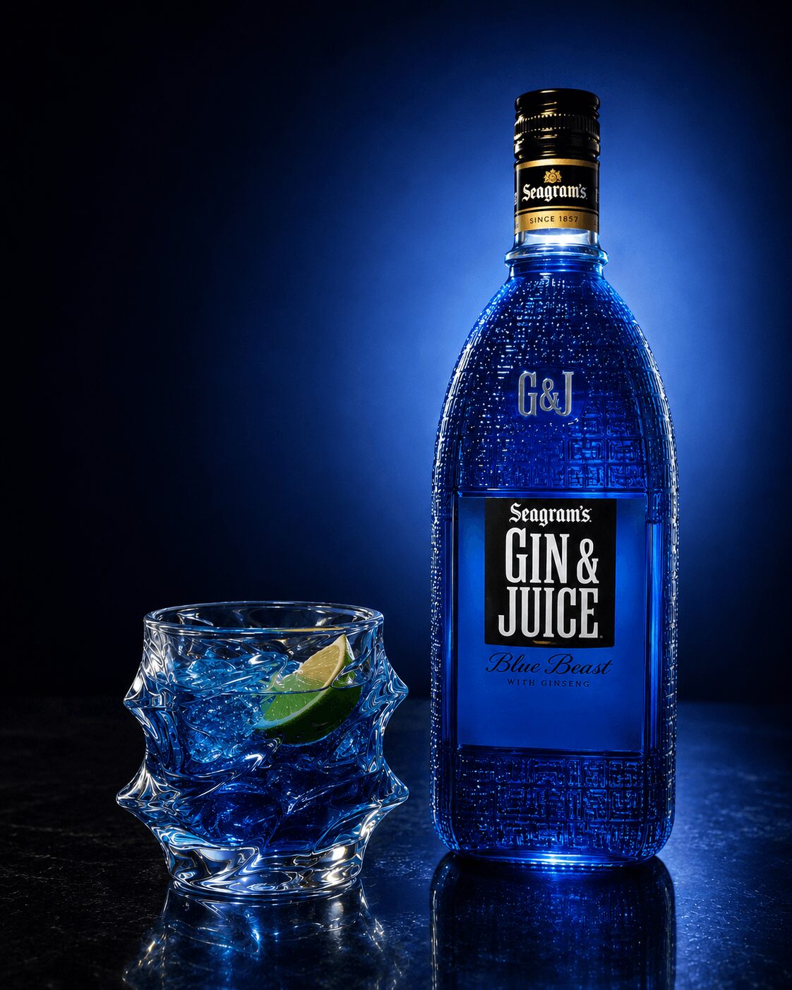 Bottle of Seagrams GIN & JUICE and a glass with ice and lime, against a dark background.
