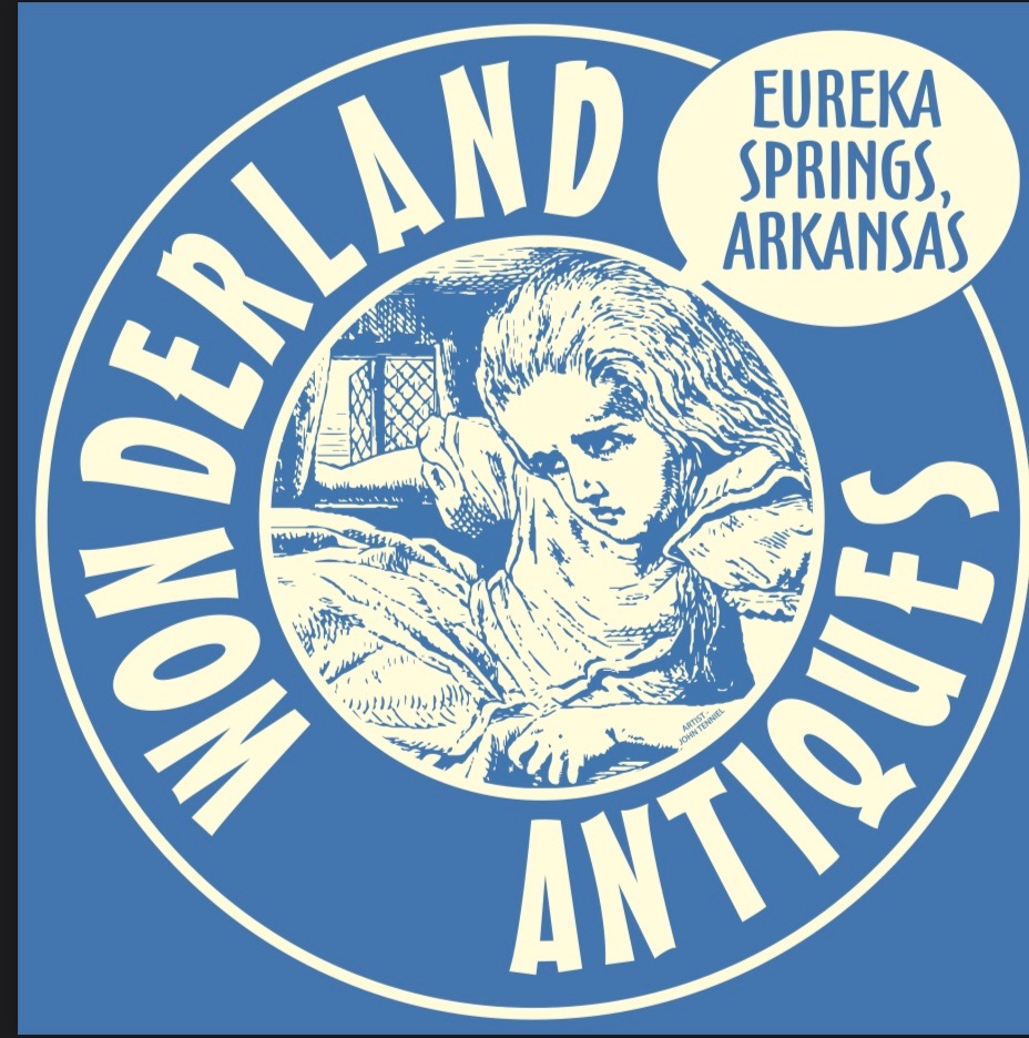 Logo with a girl resting her head on her hand, surrounded by text: 'Wonderland Antiques' and 'Eureka Springs, Arkansas'.