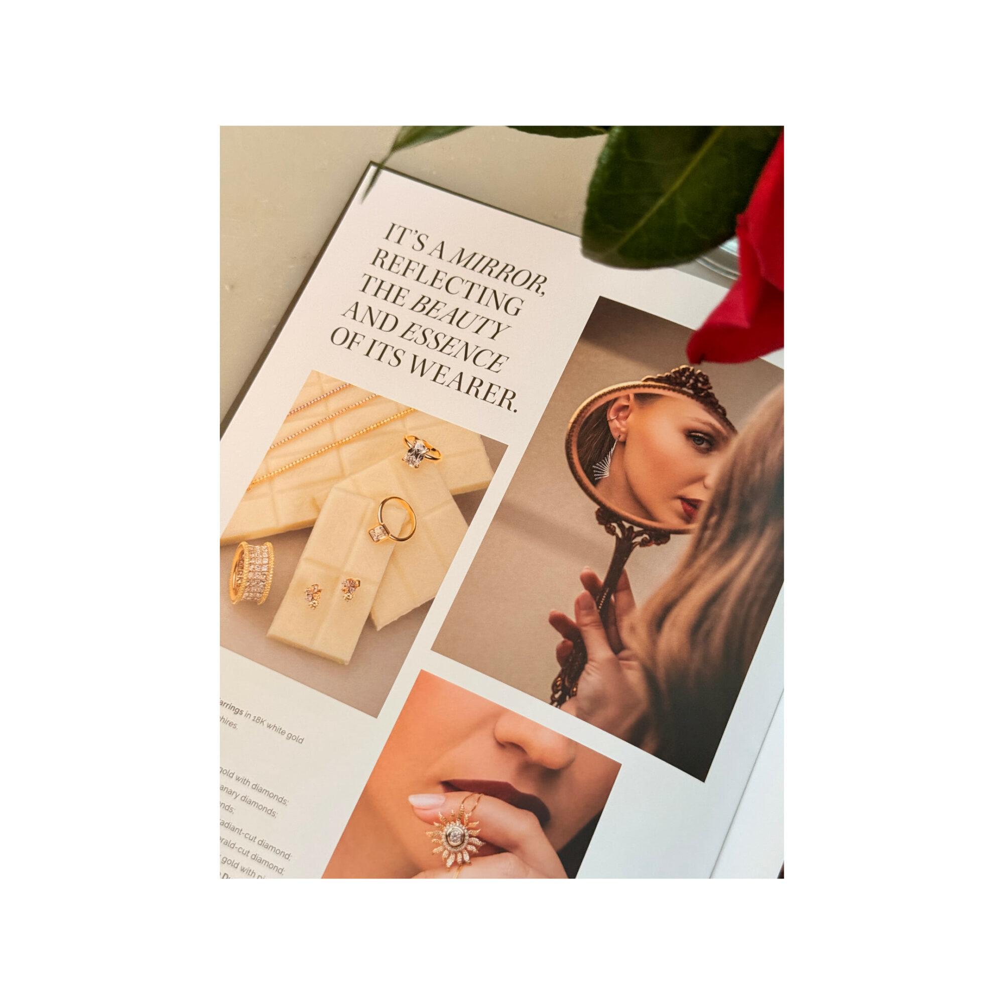 Open magazine with jewelry and makeup images, a red flower, and a quote about jewelry reflecting beauty and presence.