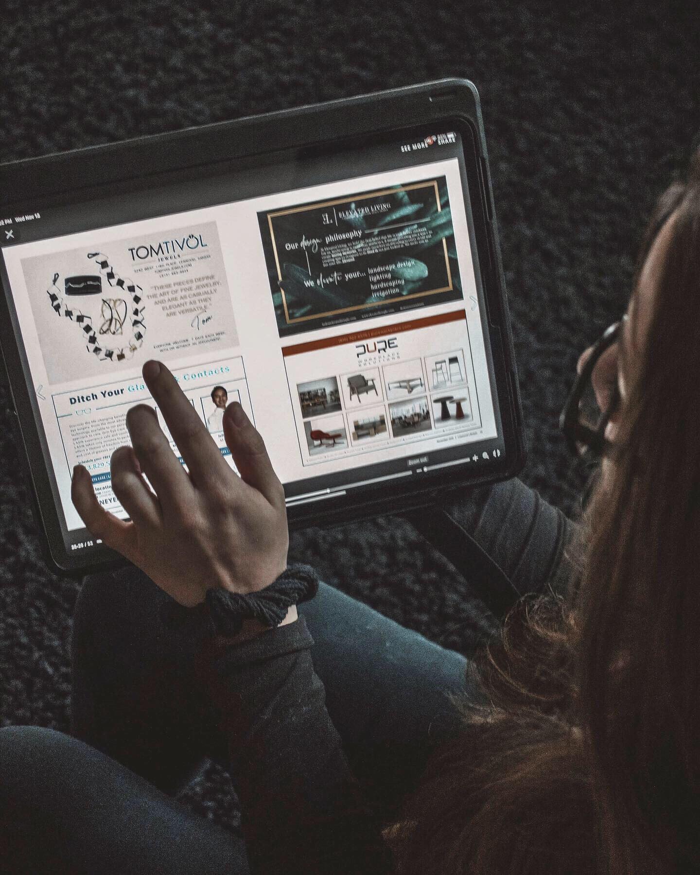 Person's hand interacts with a tablet displaying medical and product information, with a dark background.