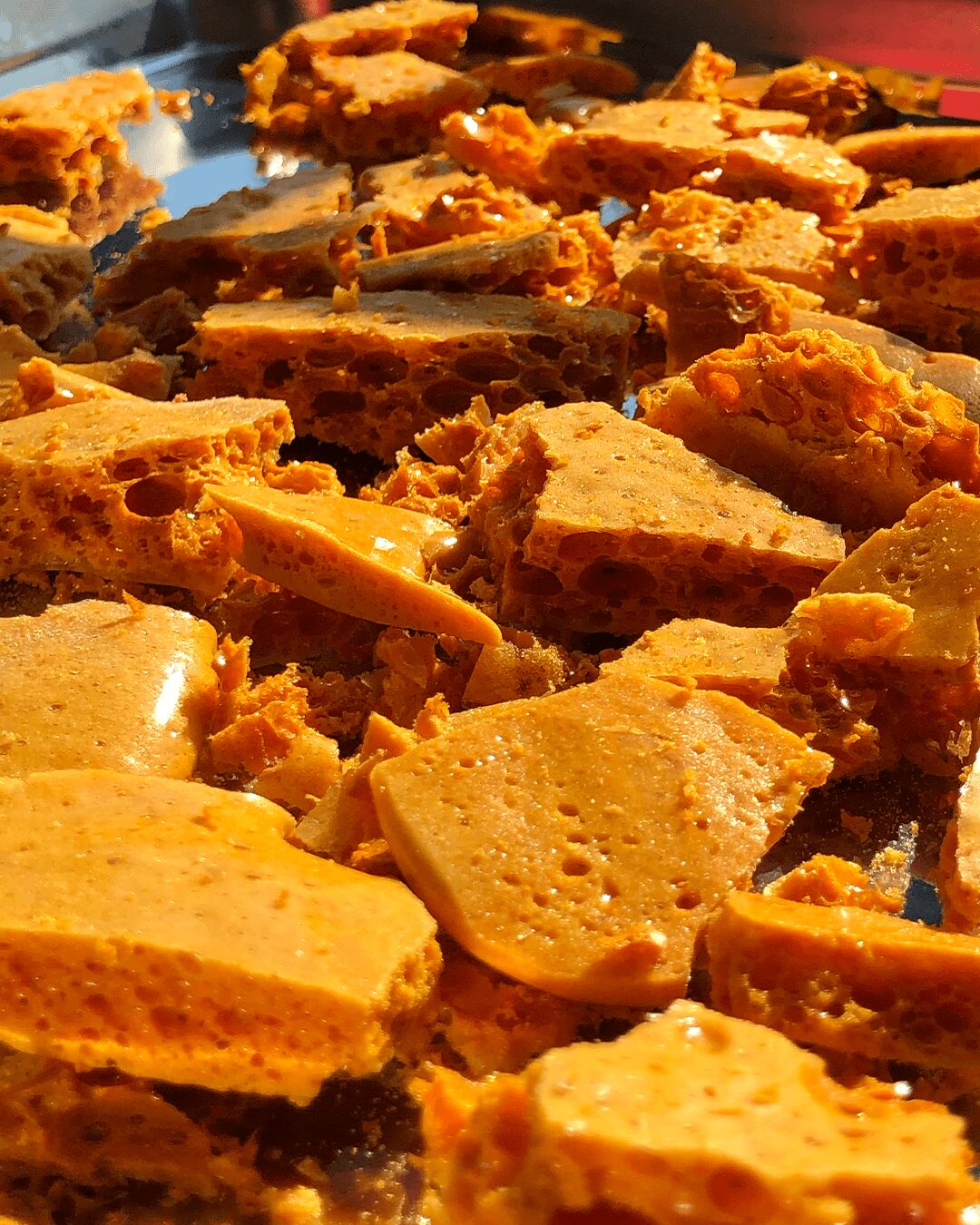 Close-up of broken pieces of a baked dish with a golden-brown crust and a filling inside.