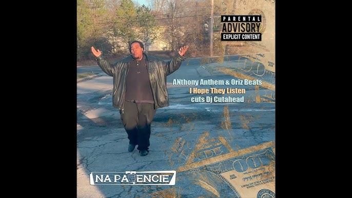 Person walking outdoors with arms raised, trees and water in background, album cover with text and parental advisory label.