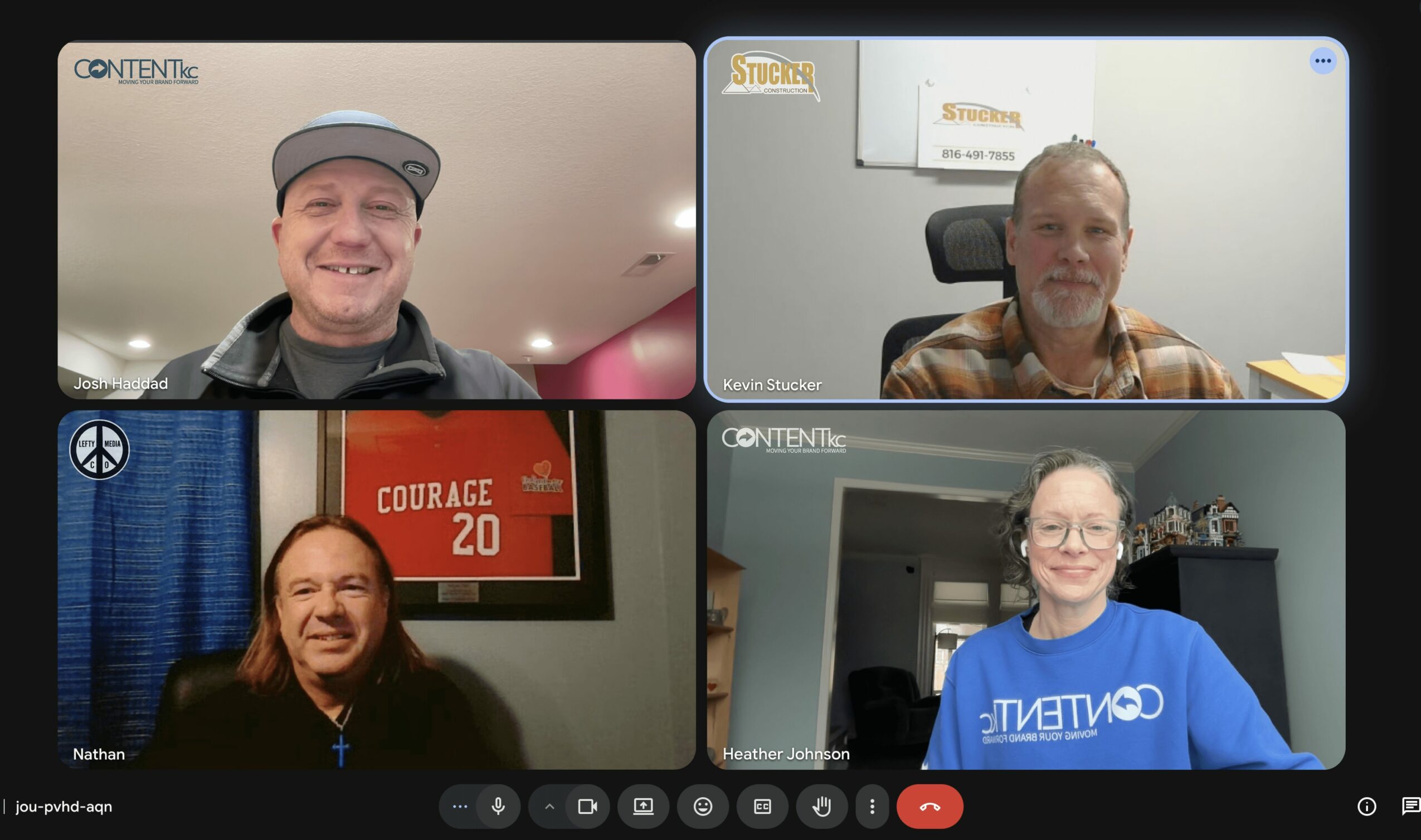 Four people in a virtual meeting, each in their own video window, smiling and looking at the camera.