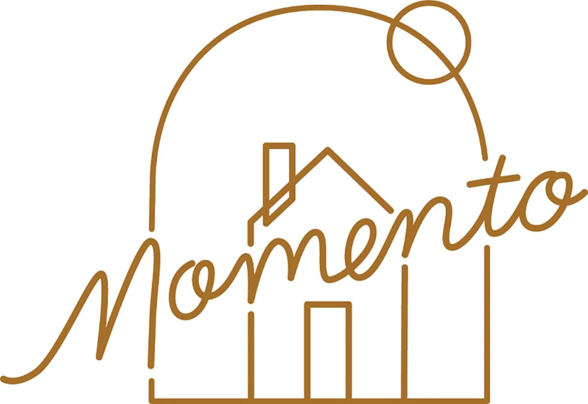 Line drawing of a house with the word 'momento' integrated into the design, featuring a circular element above.
