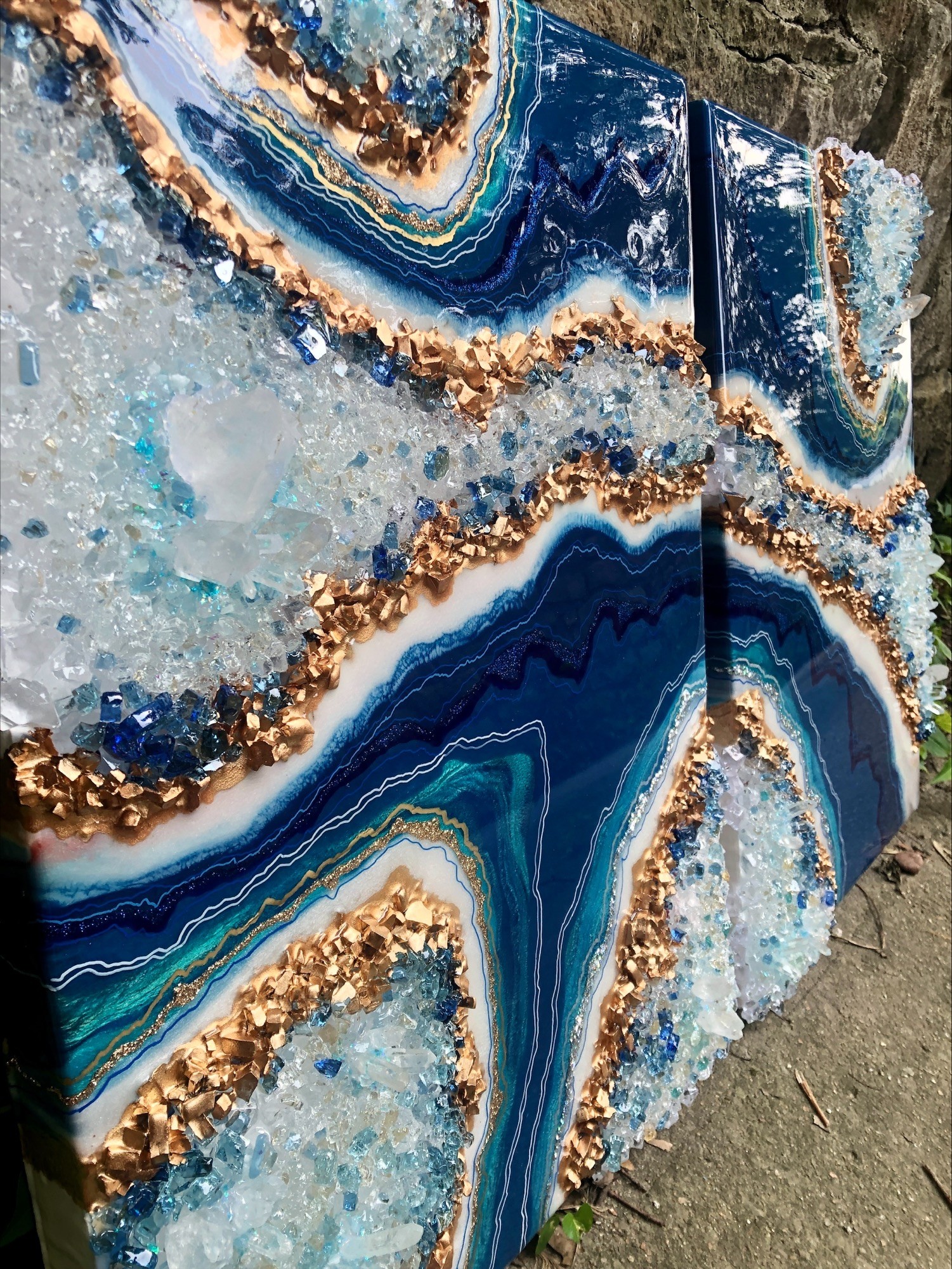 Close-up of a blue and gold geode-inspired artwork with layered patterns and textured details.