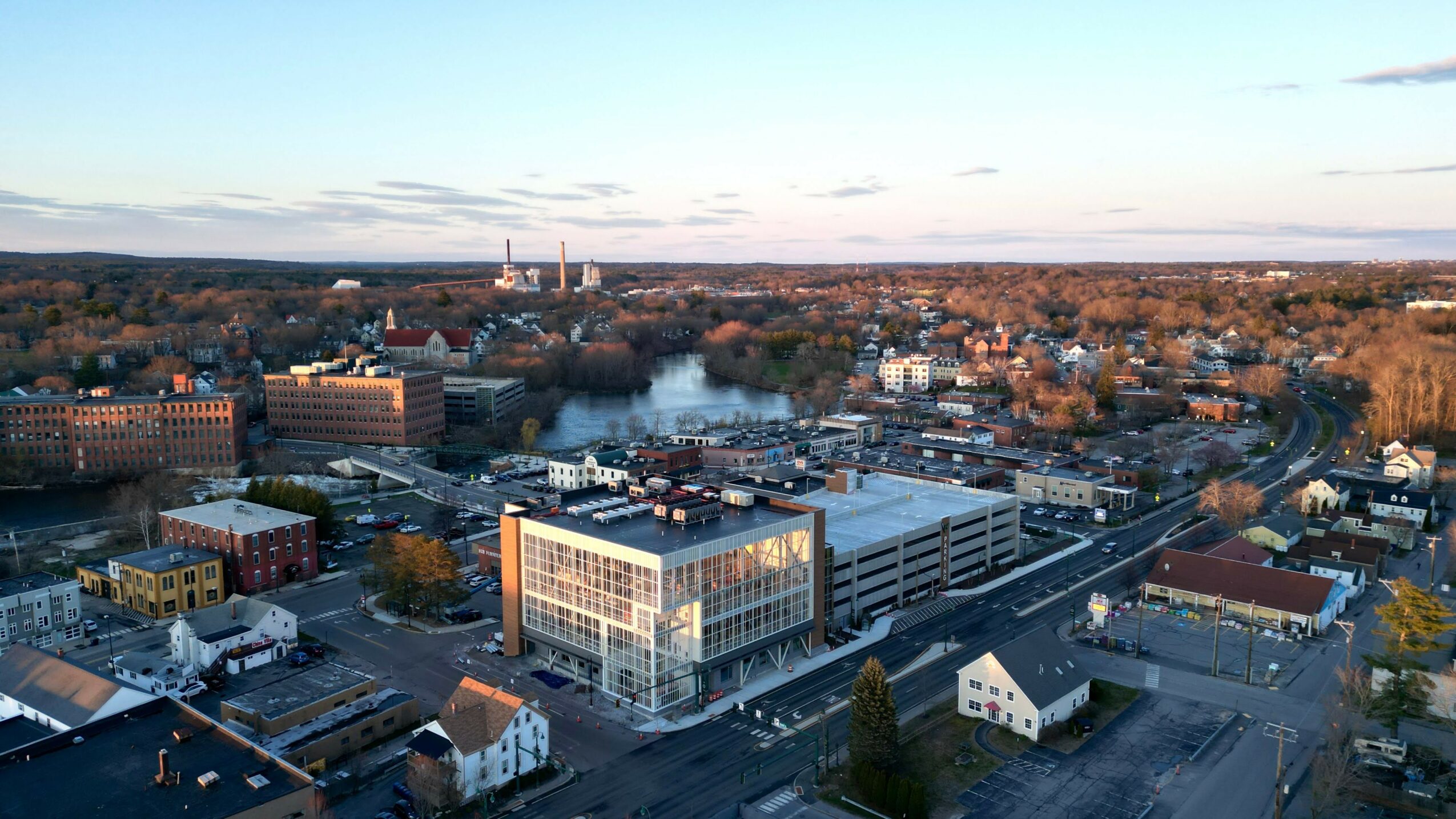 Aerial view of a city with buildings, roads, and a river in the background during daytime.