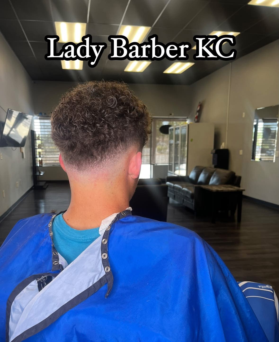 Back of a person's head with a short, curly hairstyle, sitting in a salon chair, with text 'Lady Barber KC' above.