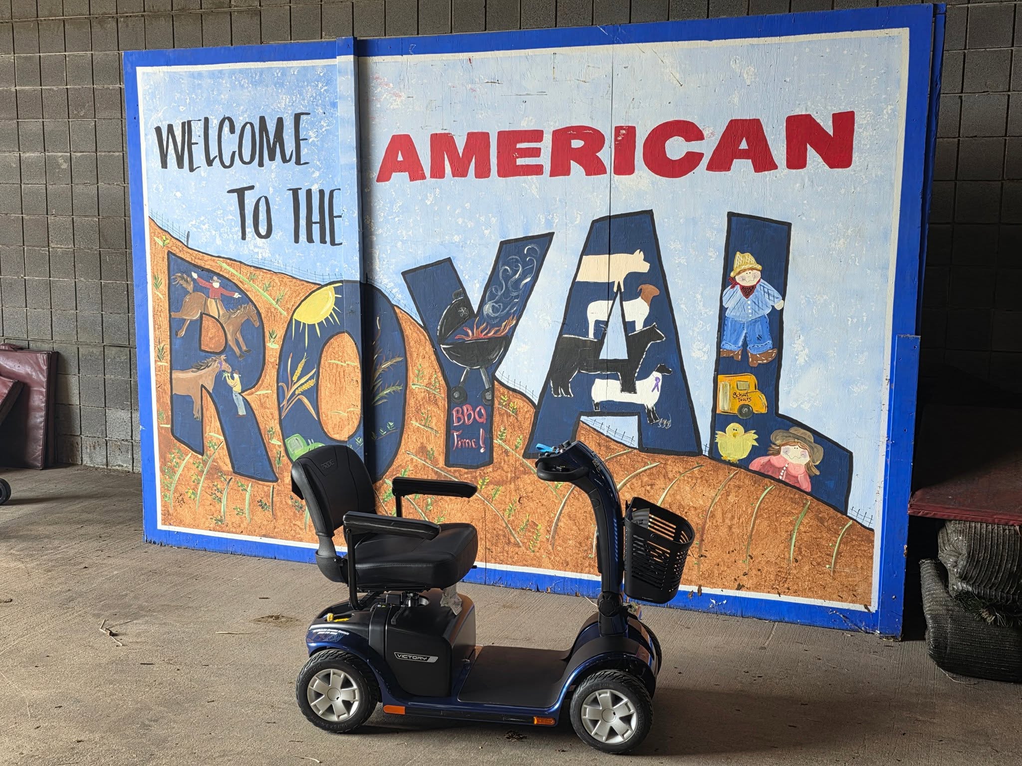 Large colorful welcome sign with the words 'Welcome to the American Royal' and decorative illustrations, on a blue background.