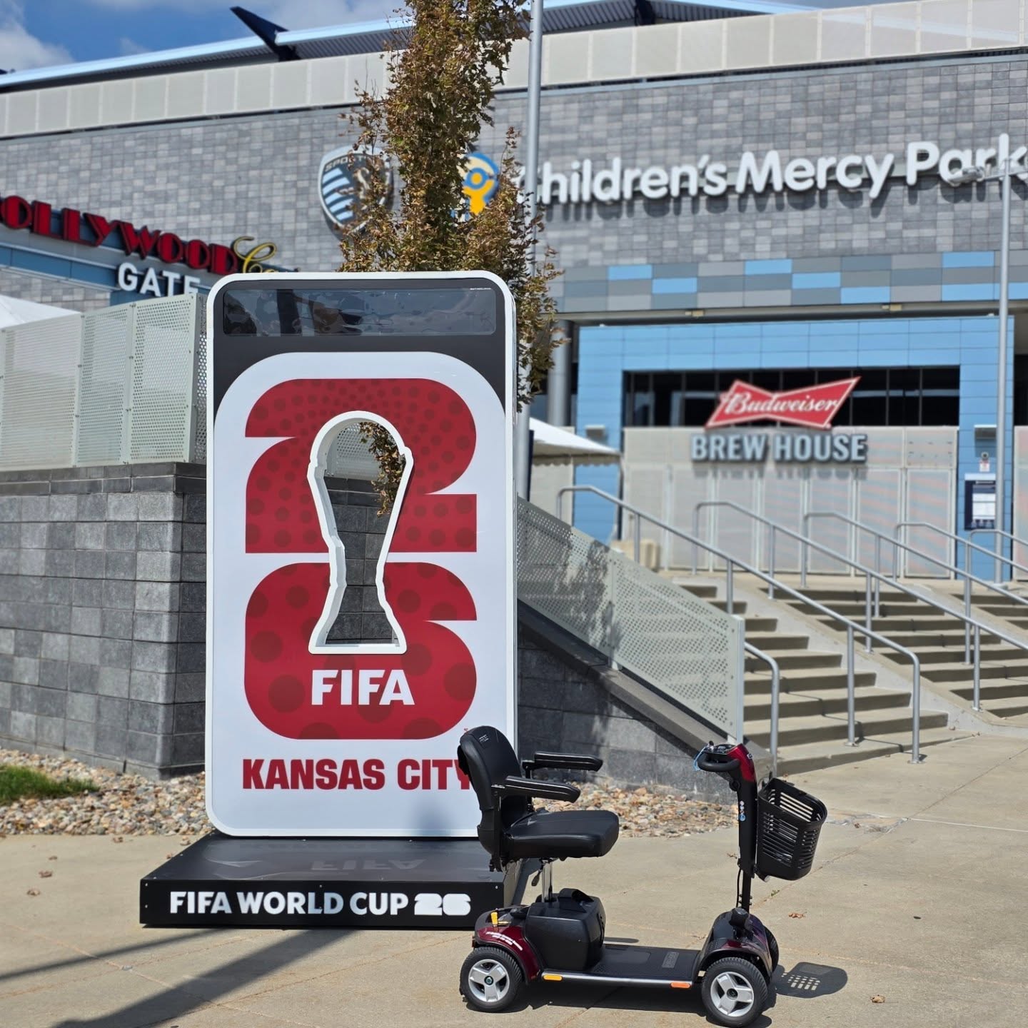 FIFA World Cup Kansas City sign outside Children's Mercy Park, with a scooter in front.