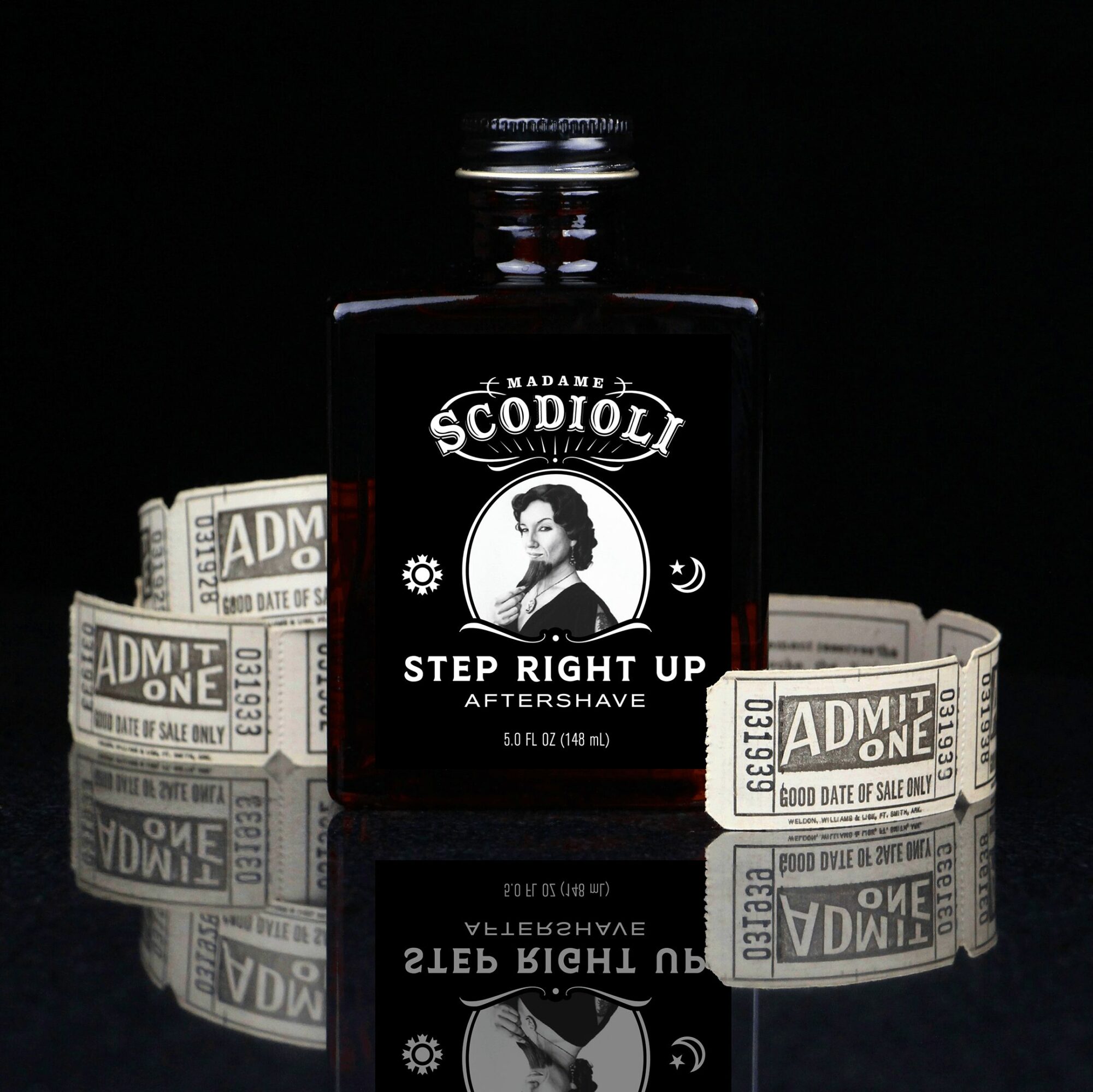 Black bottle labeled 'Madame SCIODOL Step Right Up' with a woman's portrait, surrounded by dollar bills, on a reflective surface.