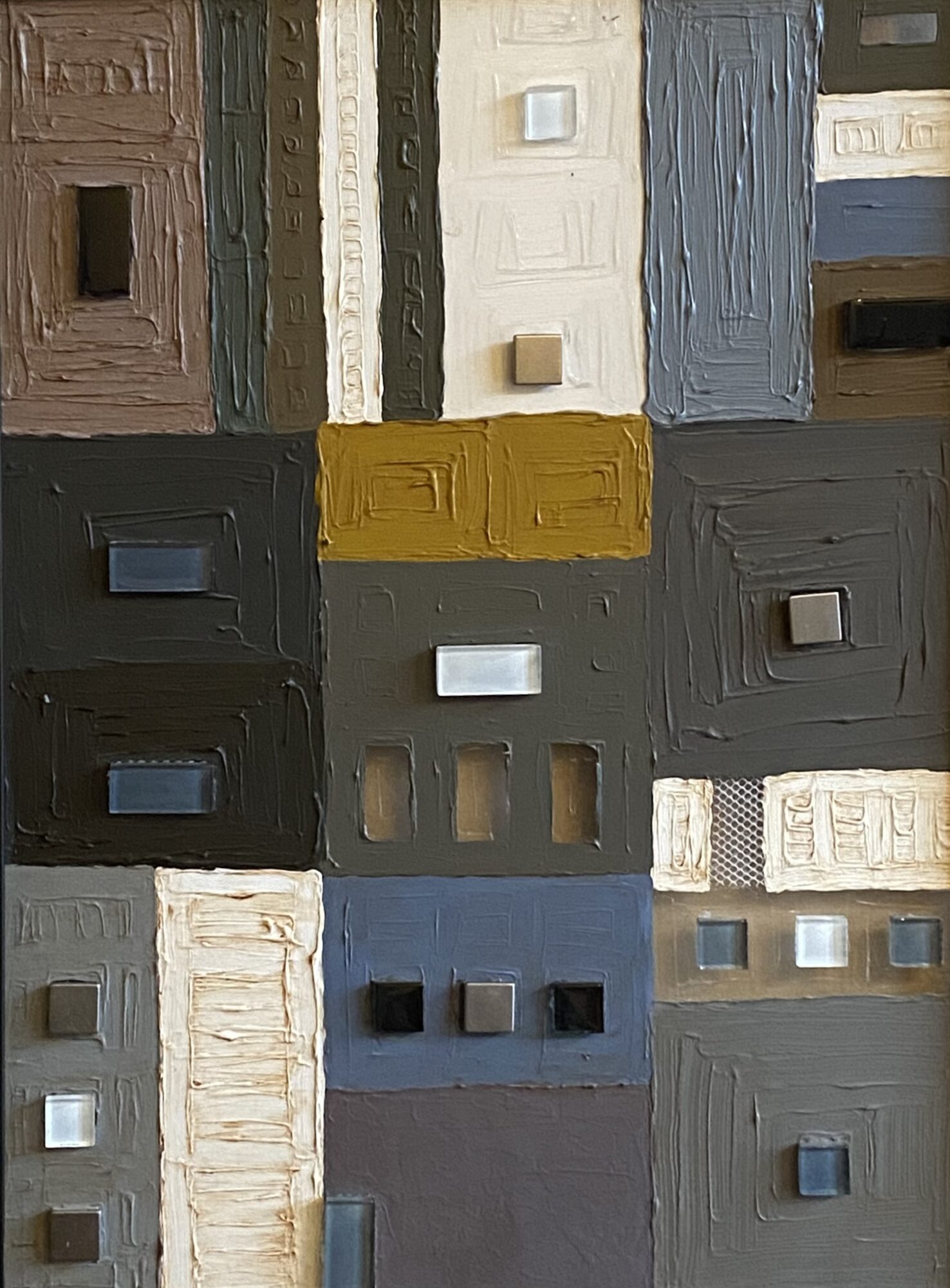 Collection of textured, rectangular blocks in various colors including brown, white, blue, black, and yellow, arranged in a grid pattern.