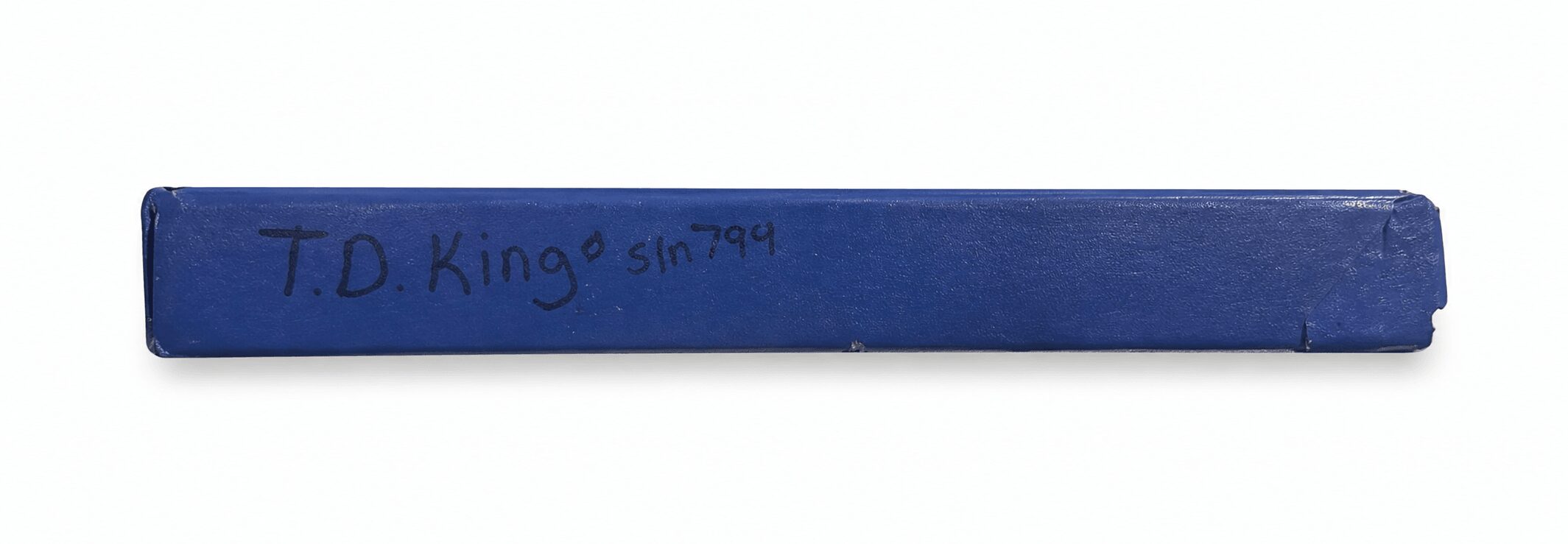Blue rectangular object with handwritten text, 'T.D King' and some numbers.