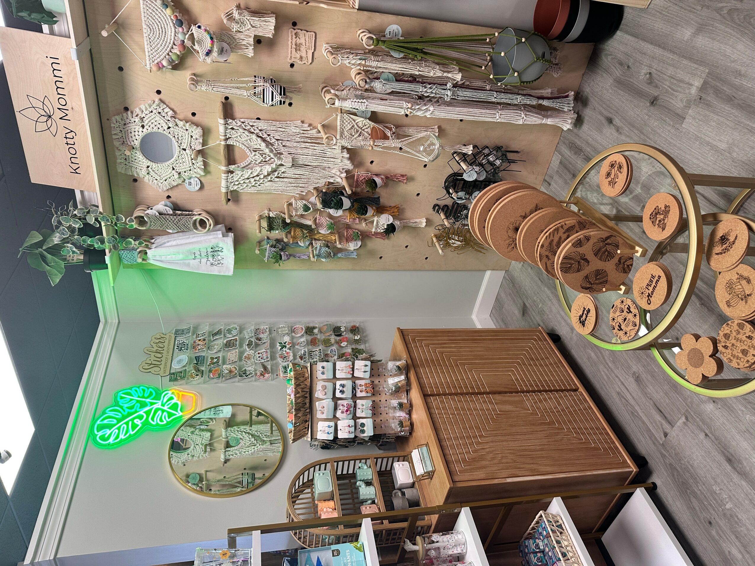 Display of decorative items, jewelry, and accessories on a wall and table in a boutique shop.