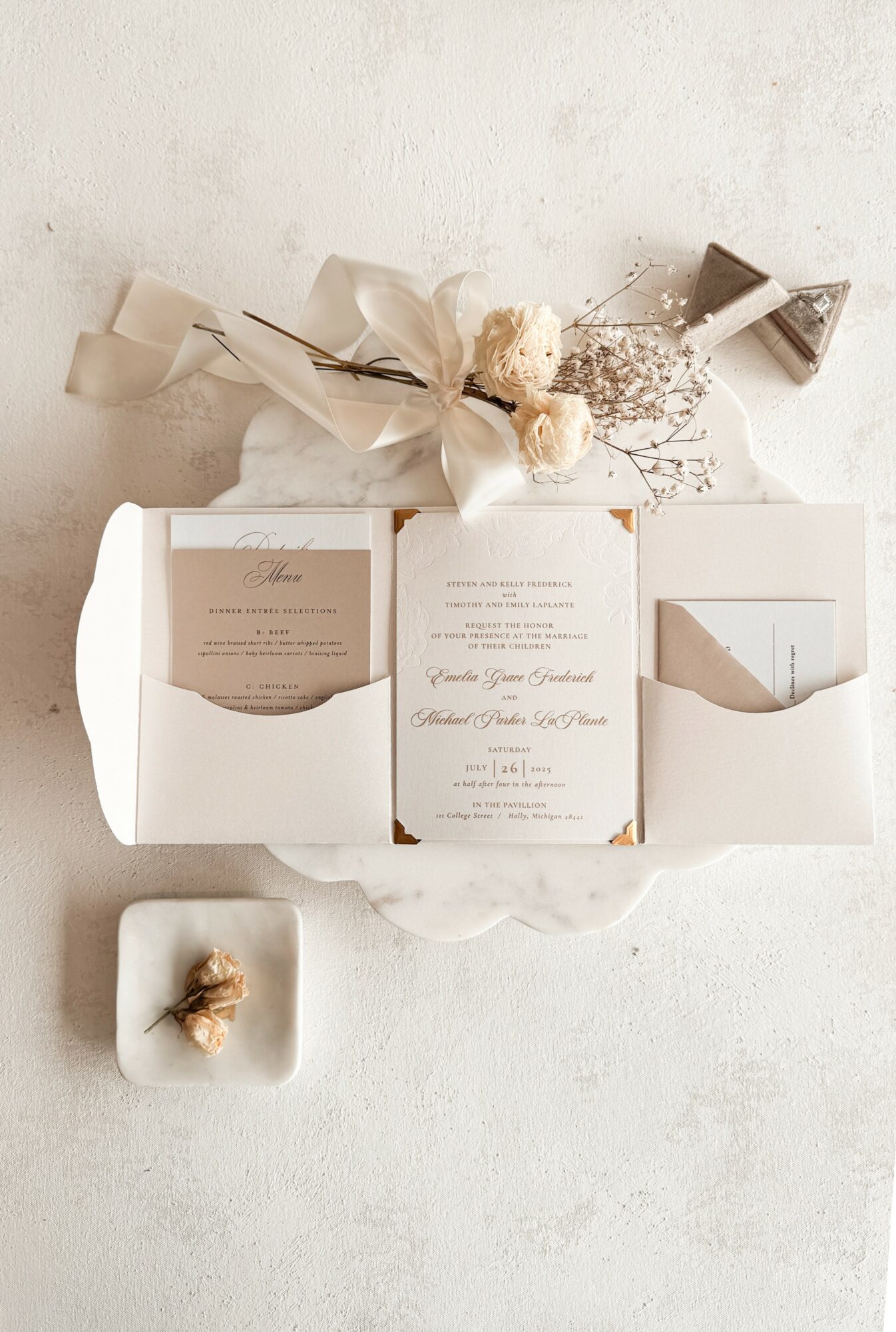 Open white box with cards and dried flowers, small dish with dried flower, on light surface, minimalistic style.