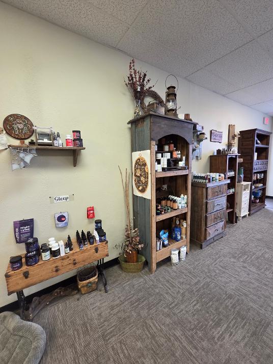 Shelves with jars, bottles, and decorative items in a store or shop interior, with a carpeted floor and ceiling tiles.