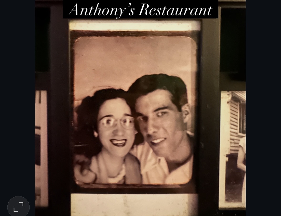 Black and white photo of a smiling woman and man, with text 'Anthony's Restaurant' above, framed on a wall.