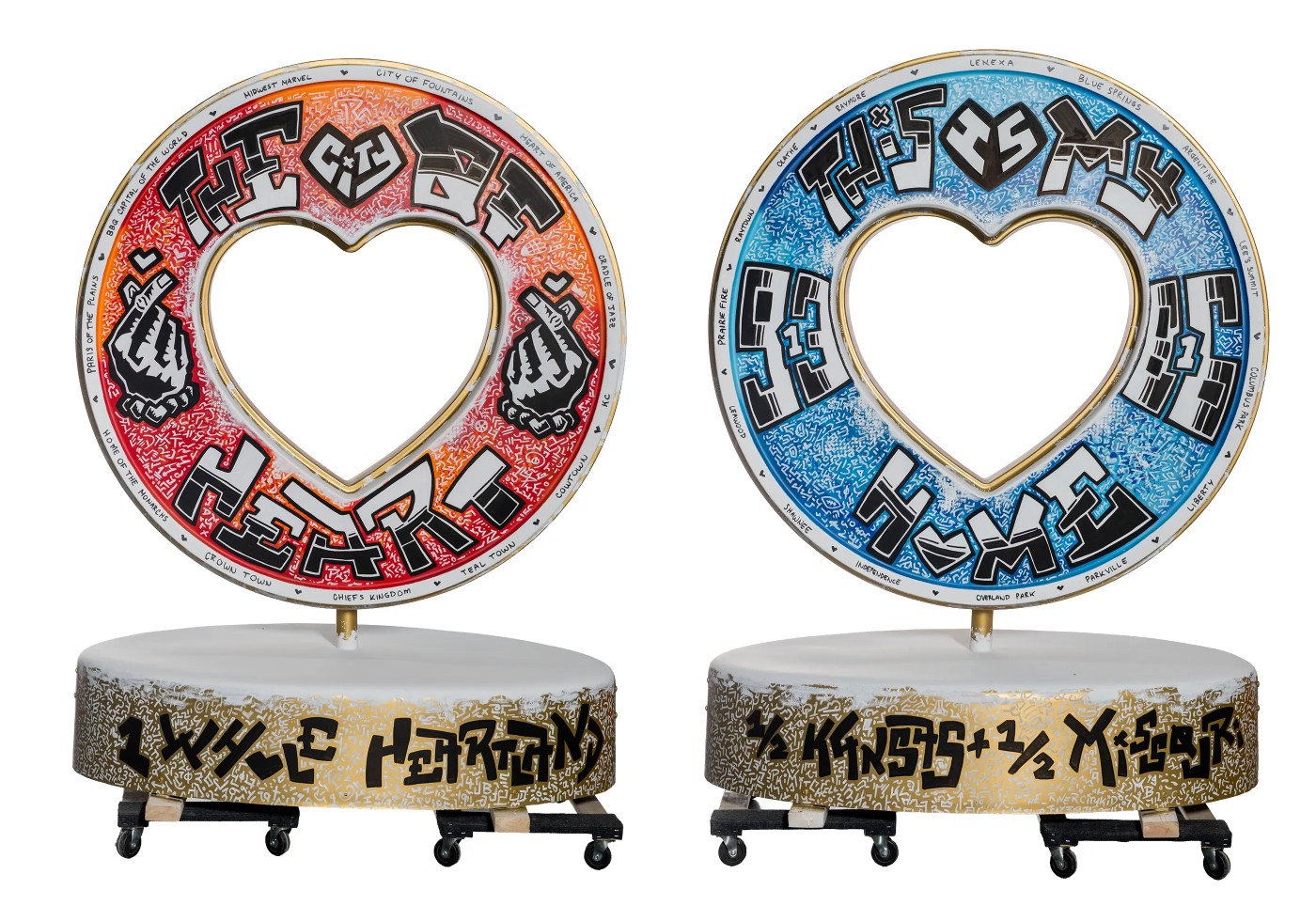 Two skateboards with circular designs and heart-shaped cutouts, one red and one blue, placed on a flat surface.