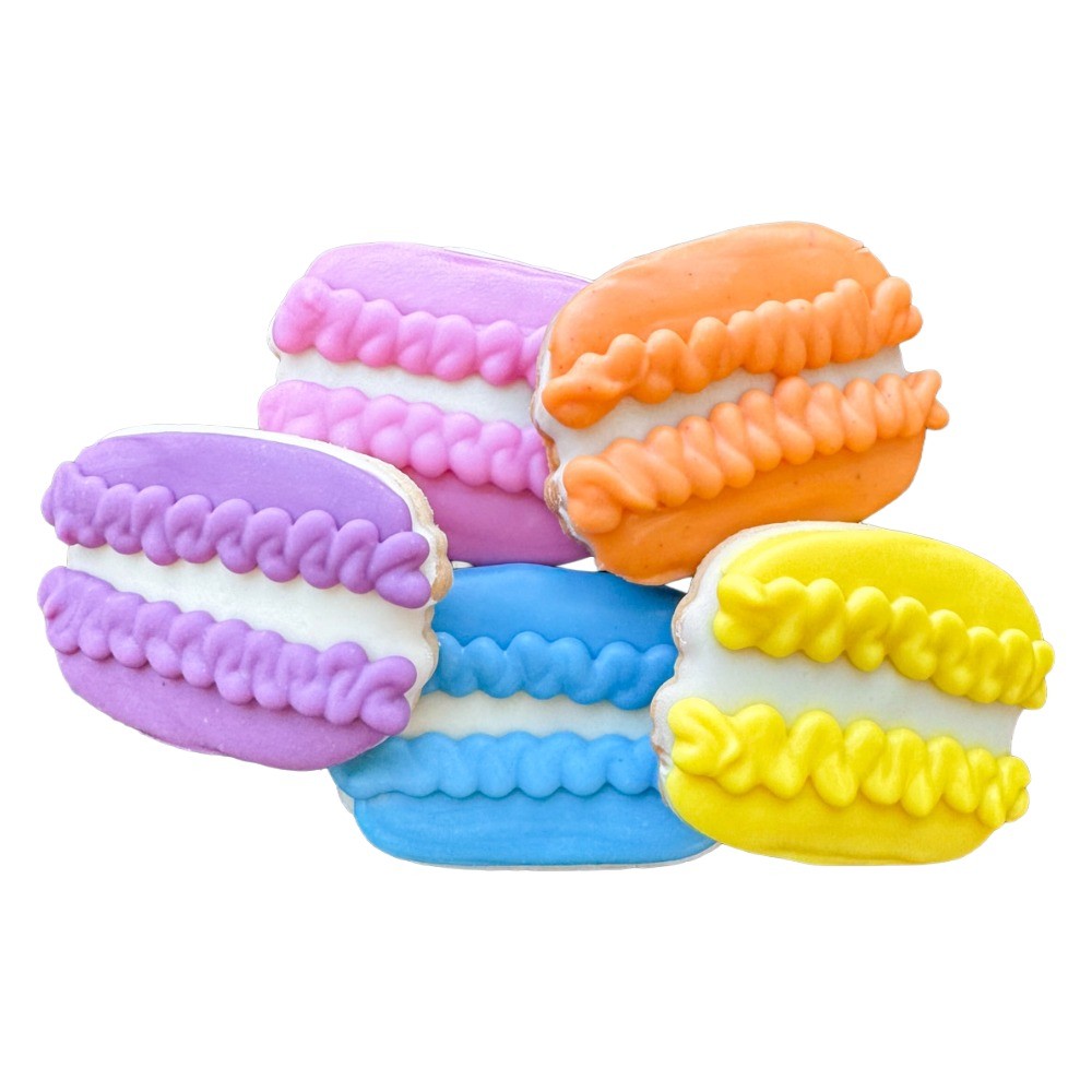 Colorful macarons stacked with purple, pink, orange, blue, and yellow, each with textured tops and smooth sides.