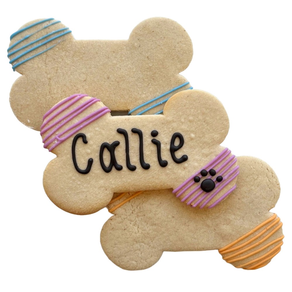 Two bear-shaped cookies decorated with colorful icing, one with the name 'Callie' written on it, and small black dots resembling eyes.