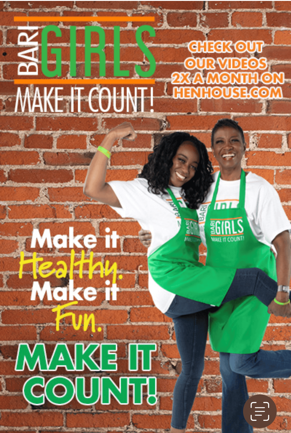 Two women smiling, one wearing a green apron, standing against a brick wall, promoting healthy living and videos online.